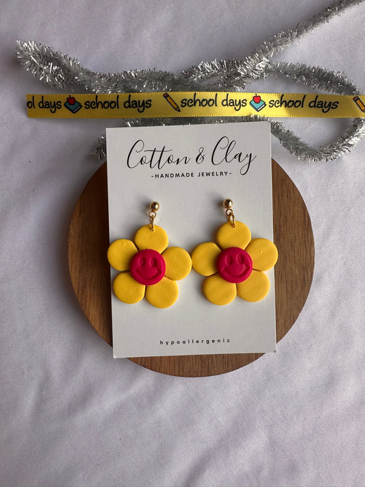 Yellow flower with pink smiley